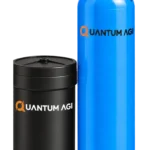 Quantum AGI automatic water softener: blue FRP vessel with a digital control valve beside a black brine tank, both with the Quantum AGI logo
